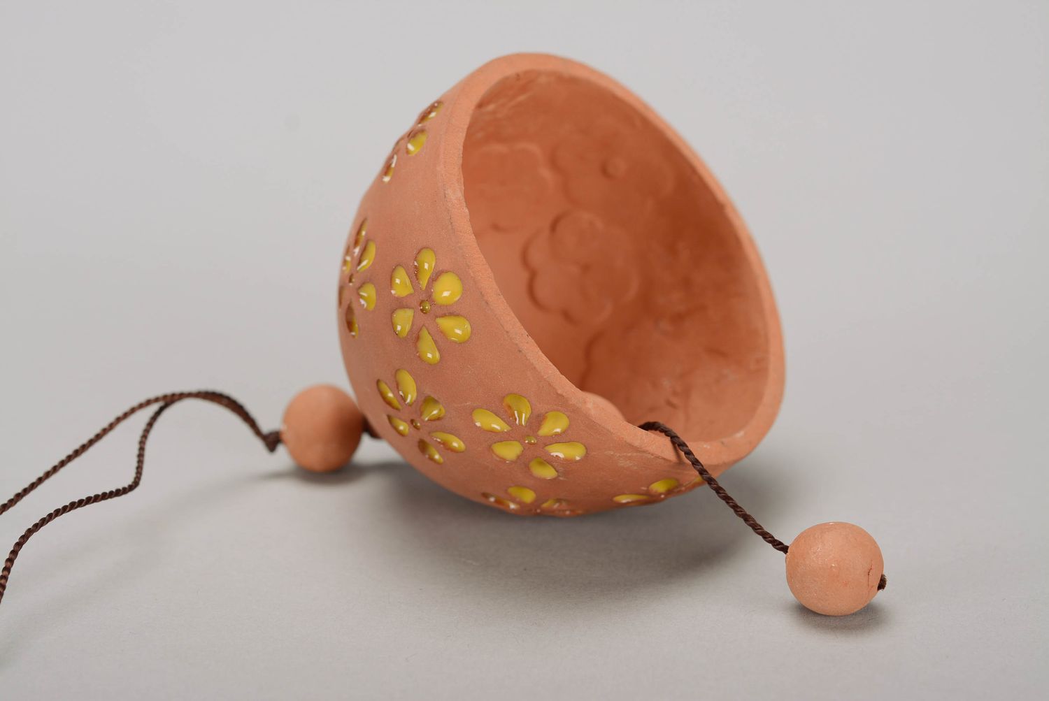 Glazed bell made from red clay photo 3