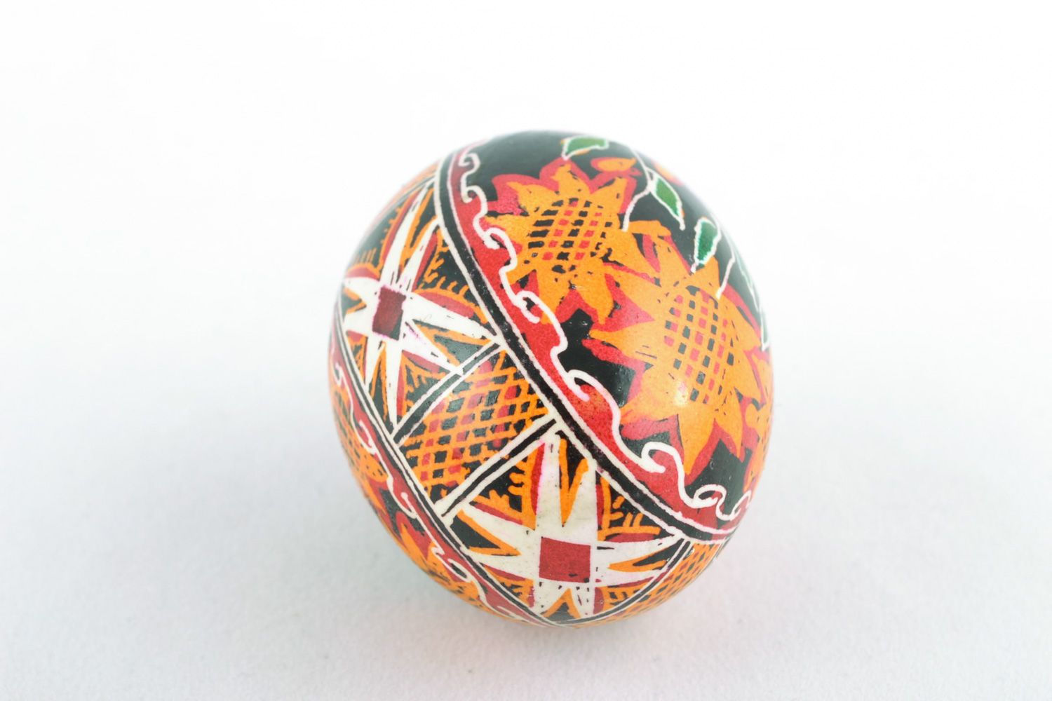 Handmade Easter egg with floral ornament on black background painted with hot wax photo 3