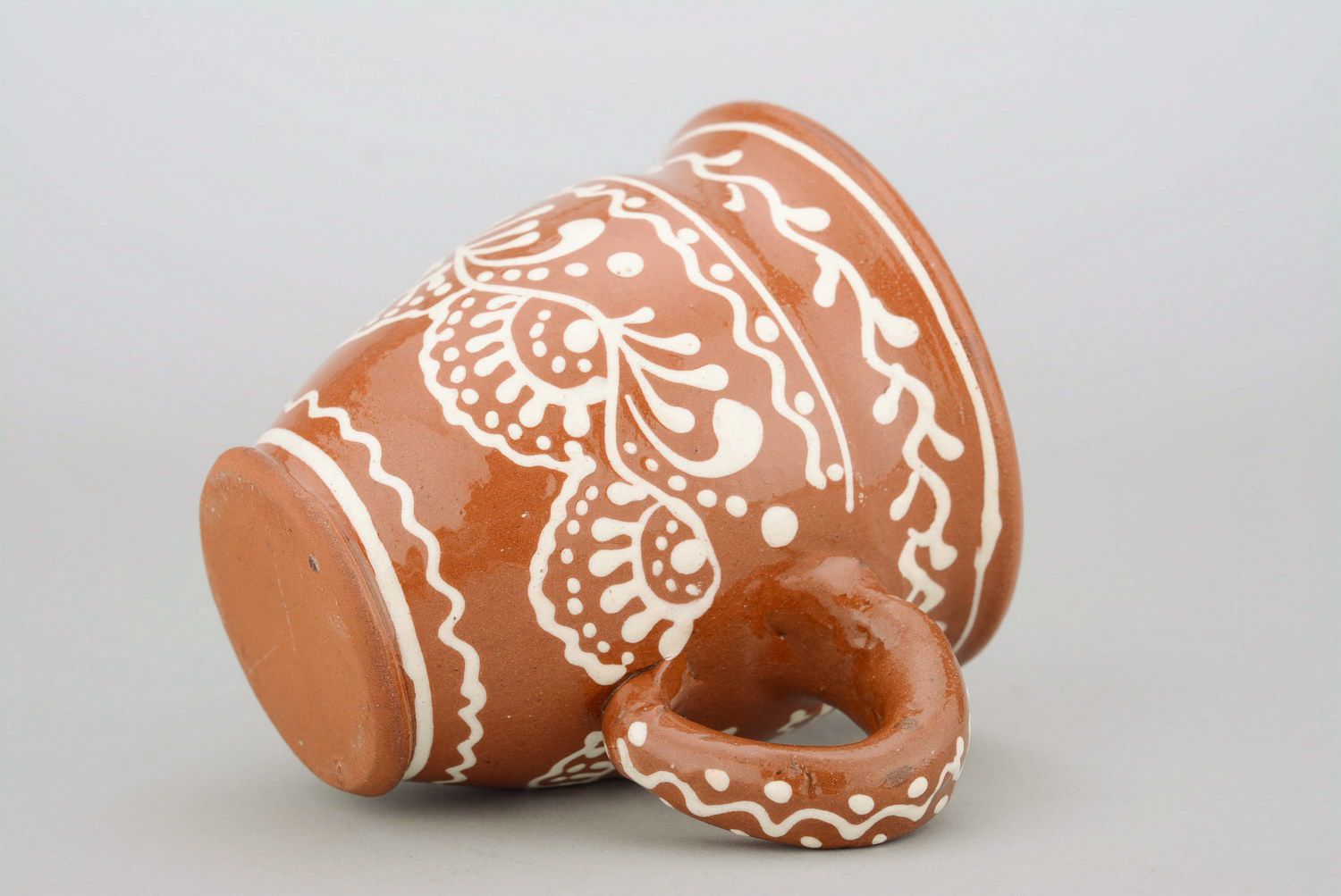 Glazed clay tea cup in terracotta color with eco pattern in white color photo 2