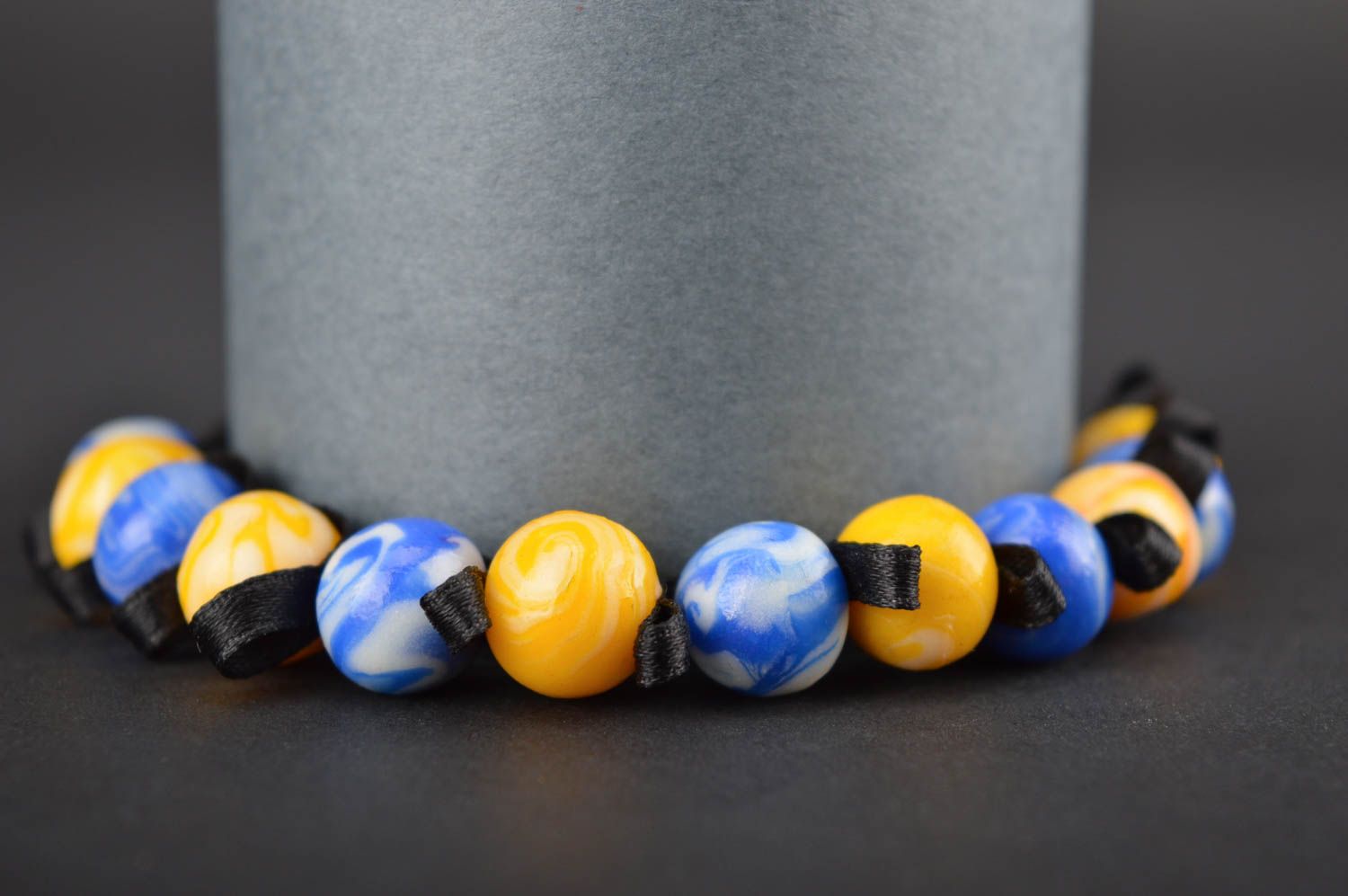 Stylish handmade yellow and blue beads bracelet on a black textile cord for her photo 1