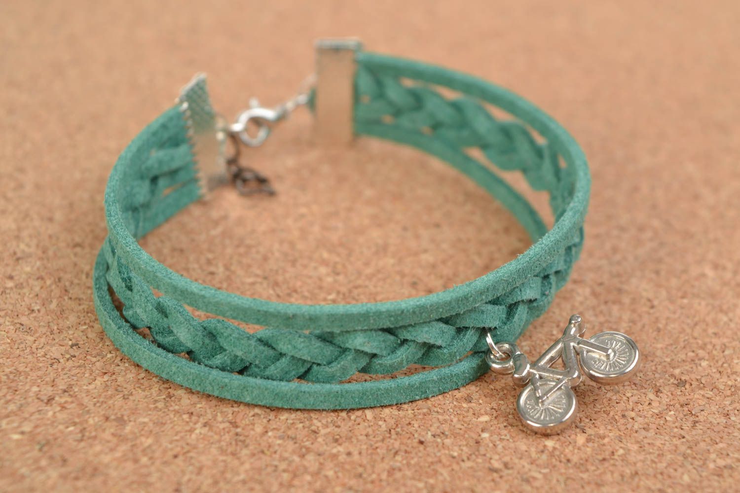 Green handmade woven suede cord bracelet with charm in the shape of bicycle photo 1