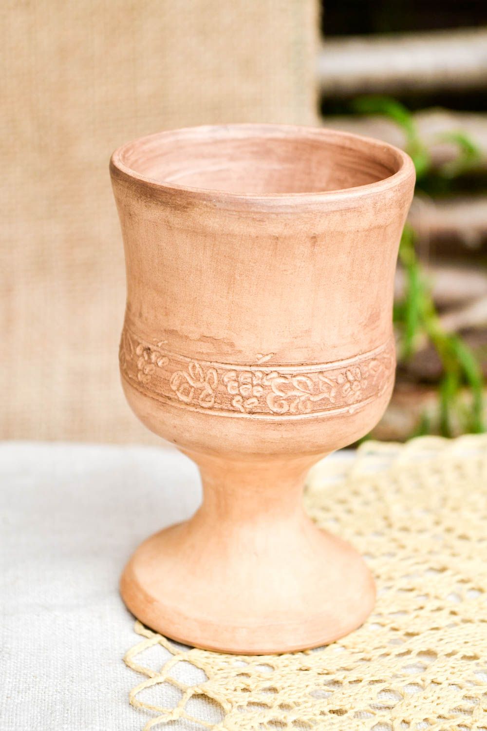 Light brown clay rustic drinking cup on stand with simple plain floral pattern photo 1