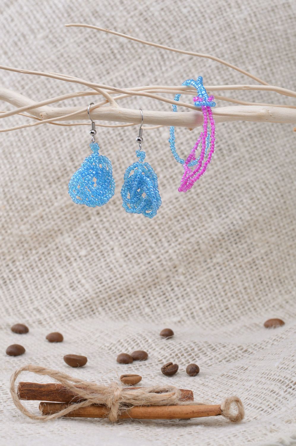 Set of handmade beaded jewelry long earrings and wrist bracelet on blue color photo 5