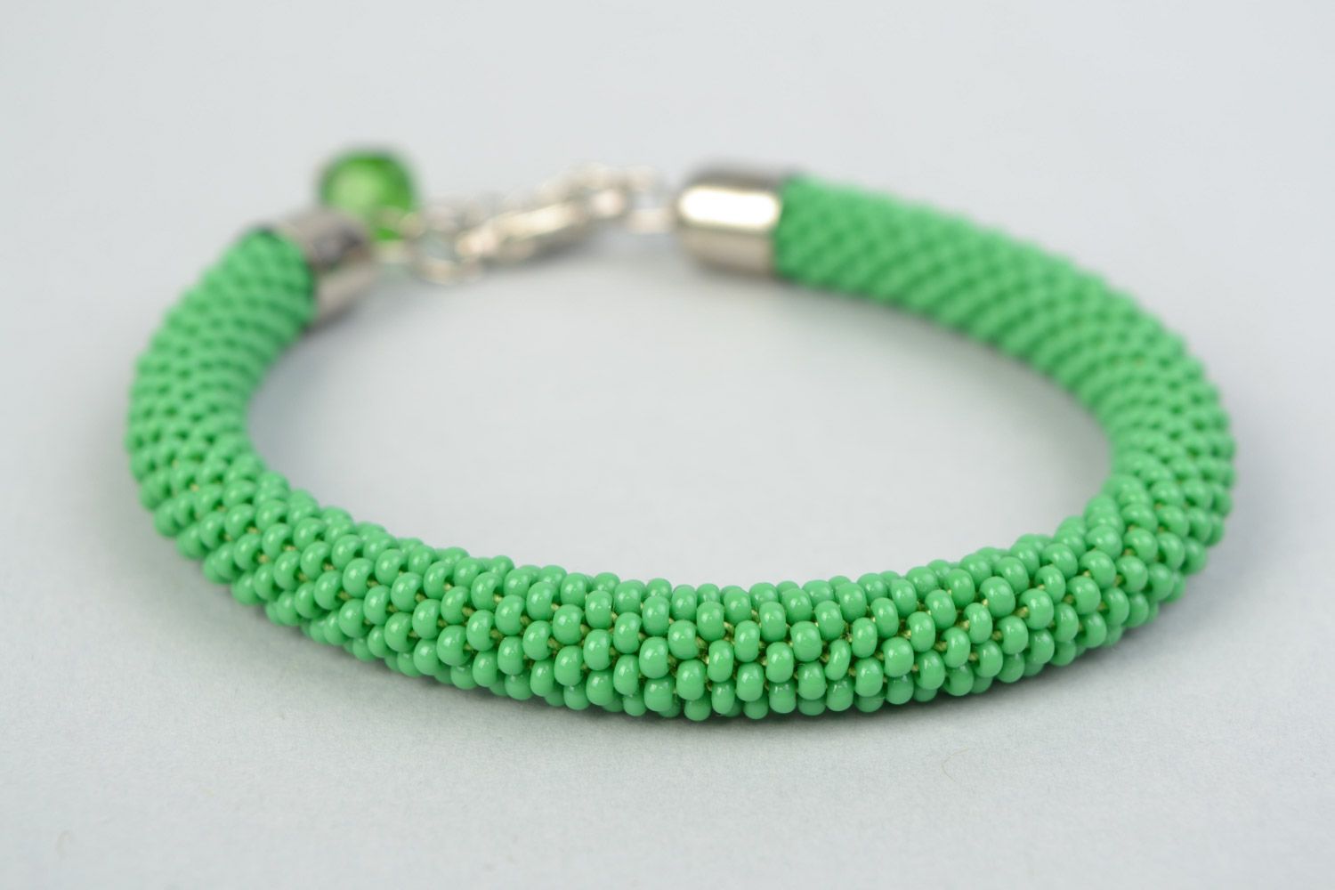 Beautiful handmade tender green beaded cord women's wrist bracelet with charm photo 3
