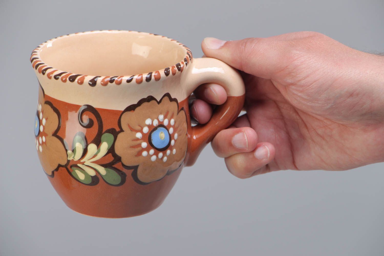 Decorative clay cup with handle and floral pattern in brown and beige color photo 5