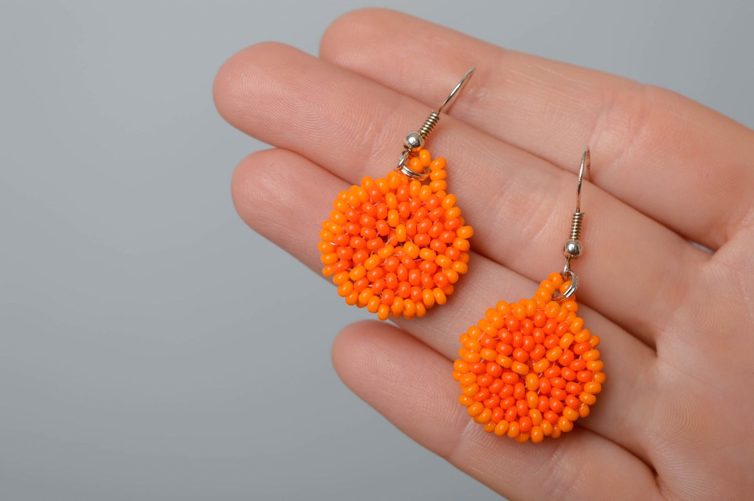 Round beaded earrings of orange color photo 2