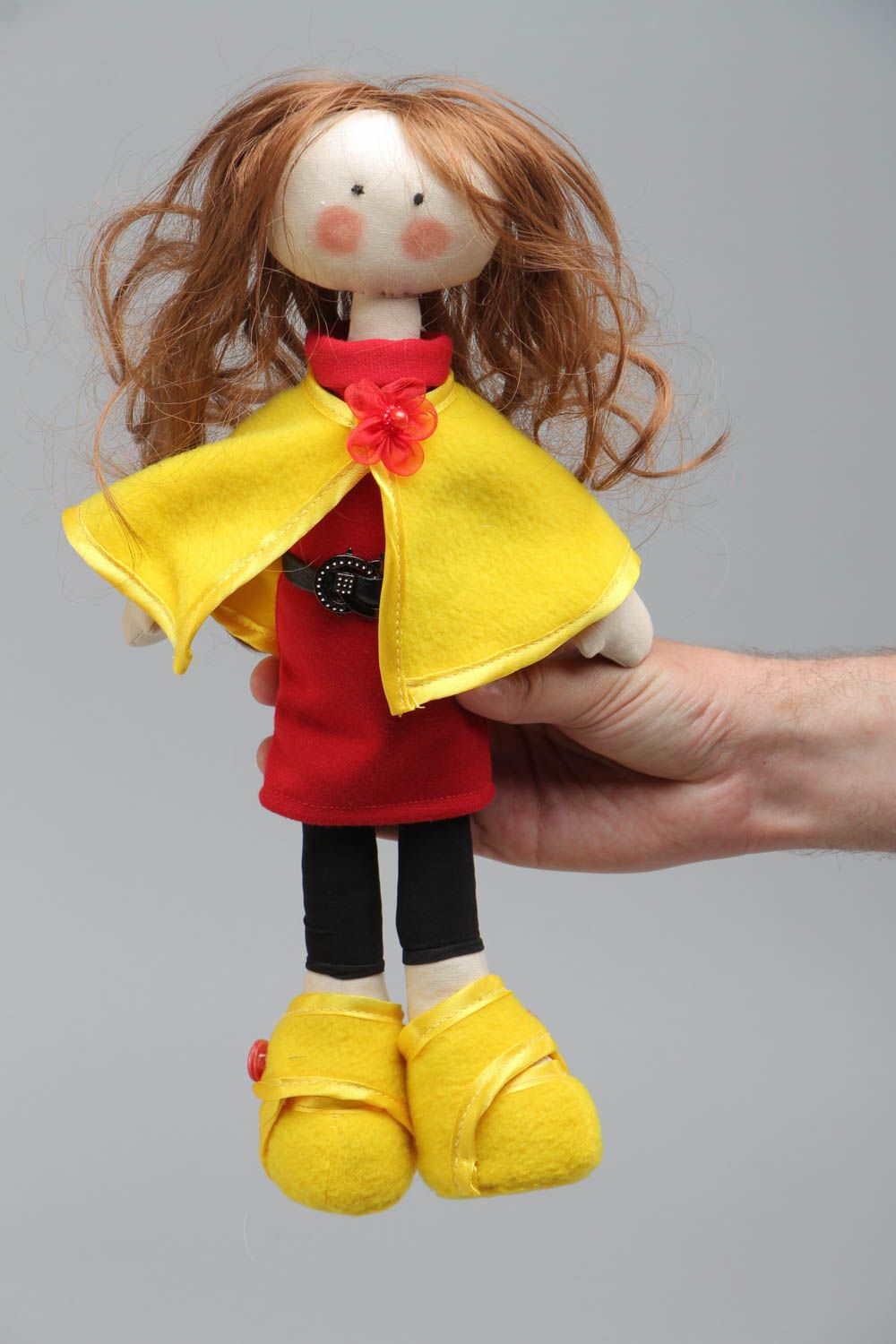 Handmade soft doll sewn of cotton fabric in yellow coat and shoes for children photo 5