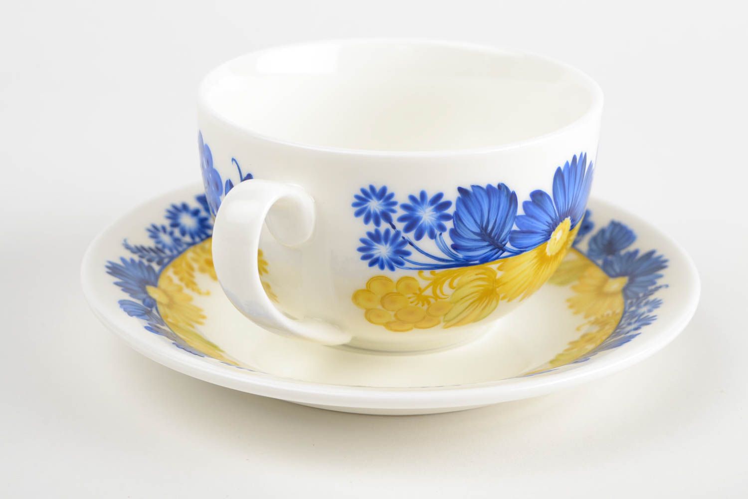 Porcelain yellow, white, and blue colors teacup in floral design with handle and saucer photo 3