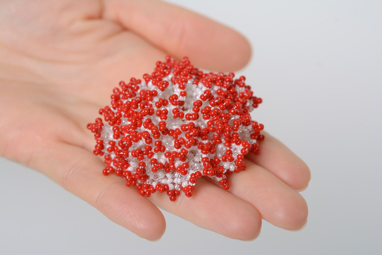 Red and white handmade brooch woven of beads in the shape of volume flower photo 2
