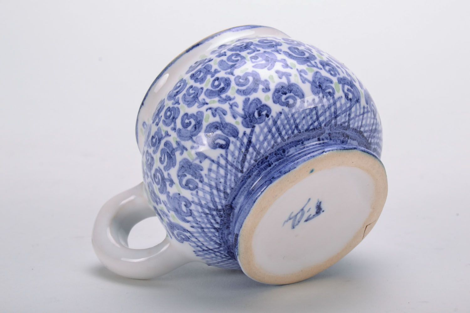 Handmade clay glazed drinking cup in white and blue color with violets' pattern photo 4