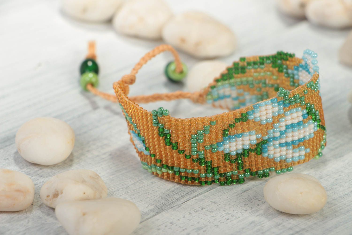Floral ornament strand bracelet in pale orange, blue, green color for young girls photo 1