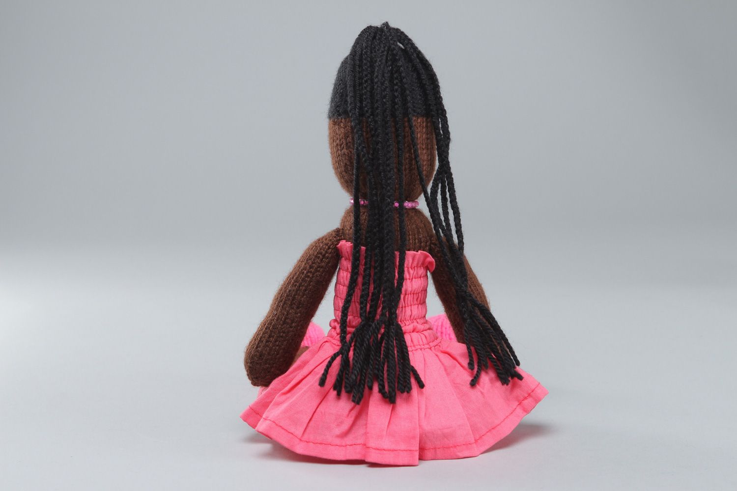 Handmade soft toy knitted of acrylic threads Mulatto in pink dress for little girl photo 3