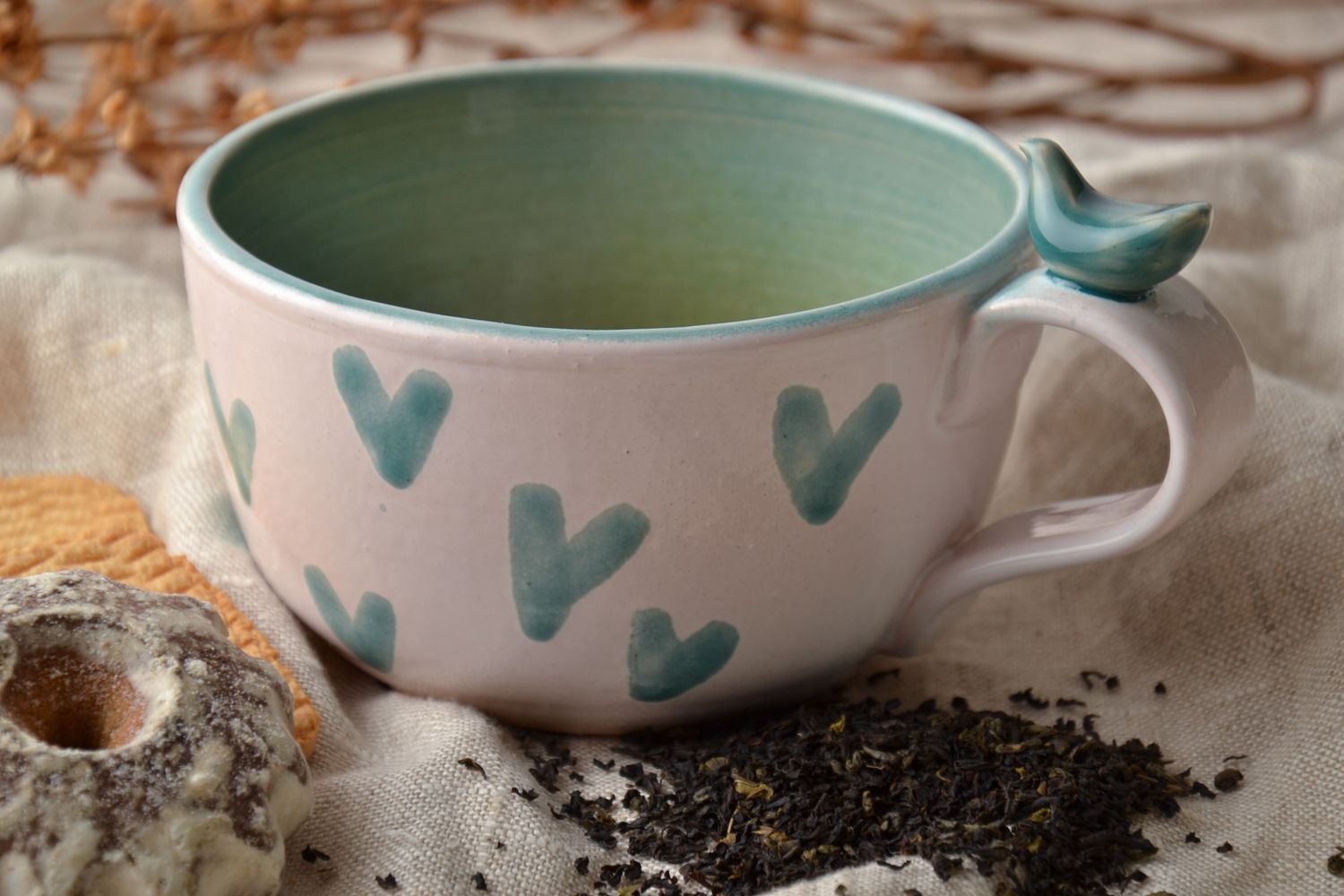 Porcelain white coffee cup with green glaze inside with handle and heart shape pattern photo 1