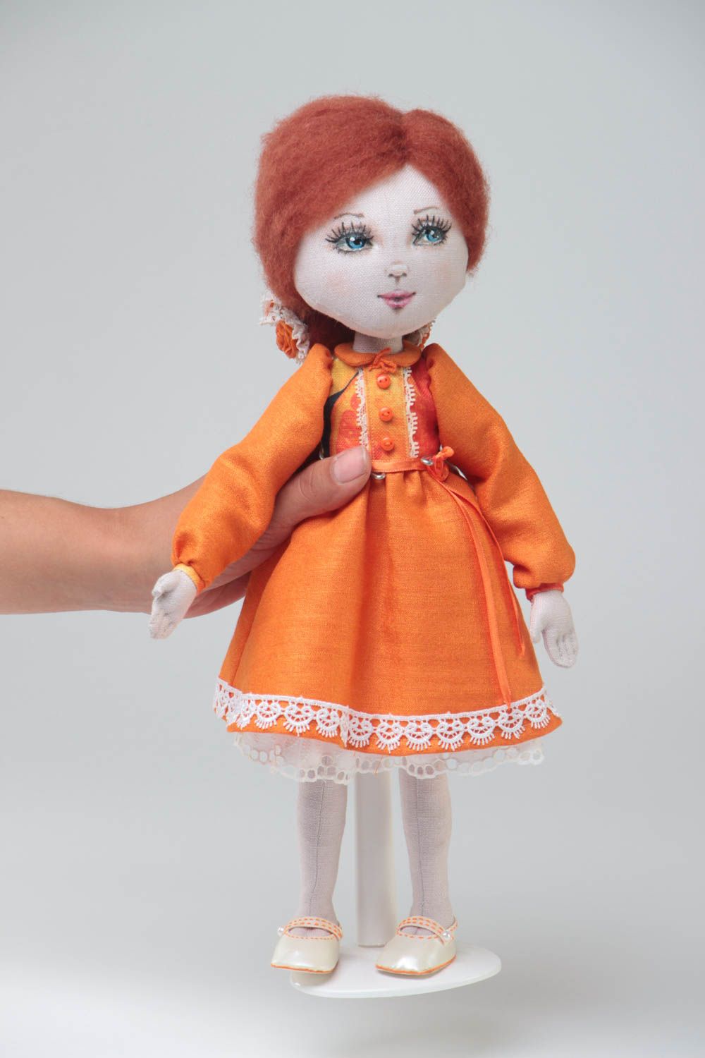 Handmade designer fabric soft doll in orange dress with thin lace on stand photo 5