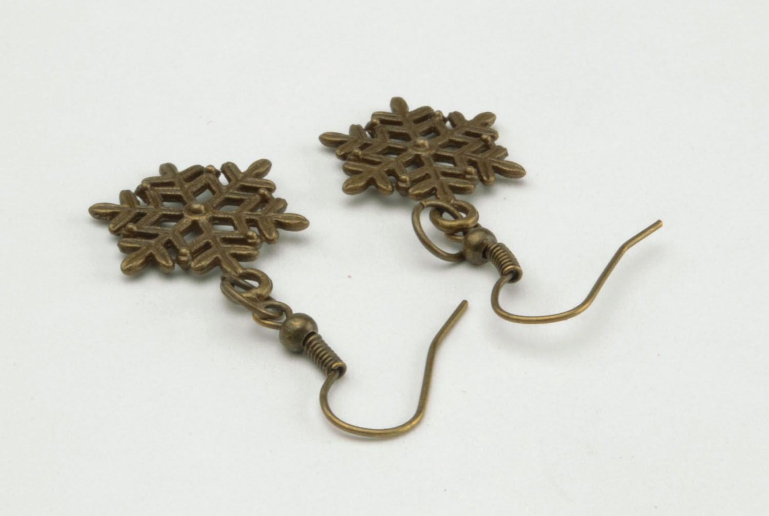 Metal earrings in the shape of snowflakes photo 4