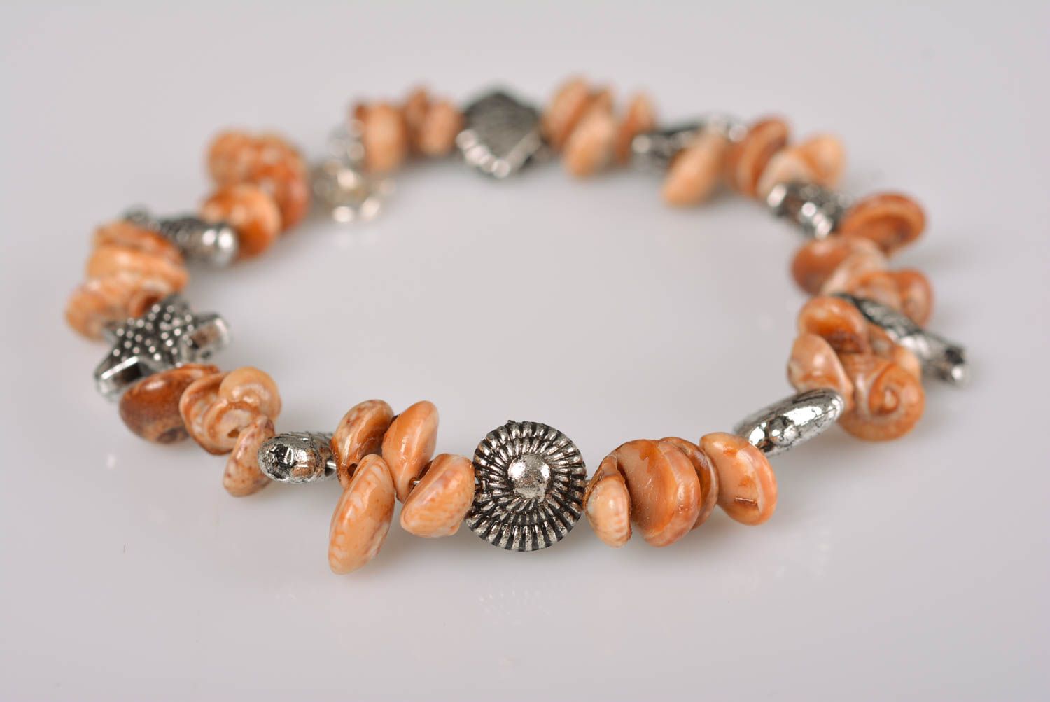 Handmade thin laconic wrist bracelet with seashells and metal charms for women photo 1