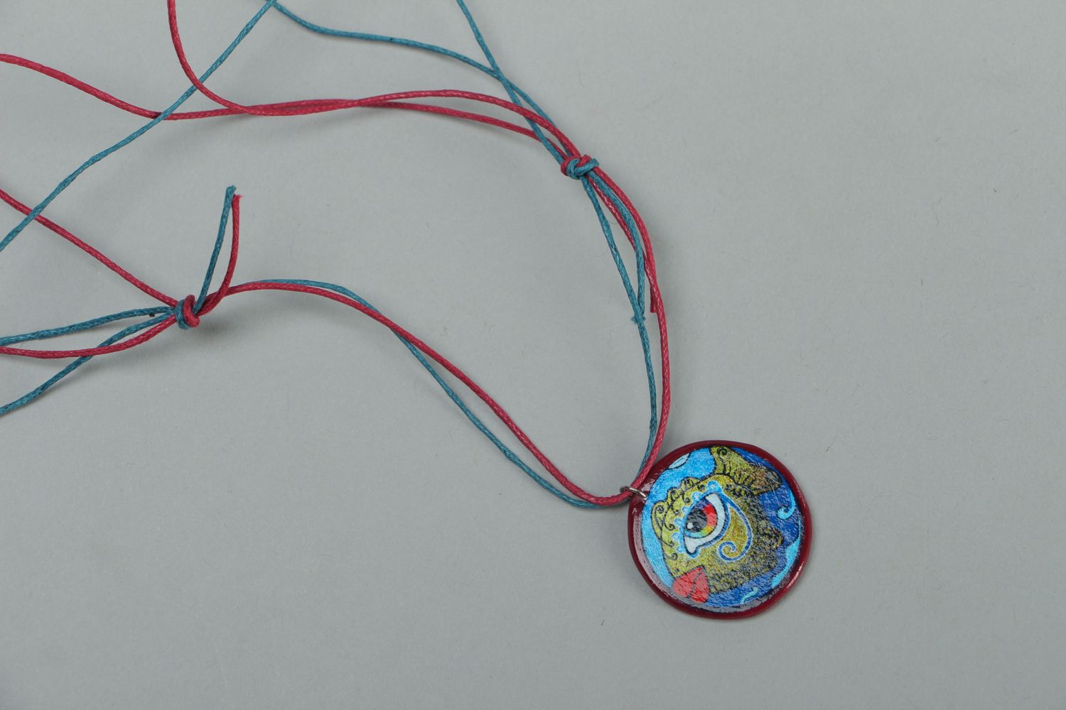 Round polymer clay pendant with drawing on a cord photo 1