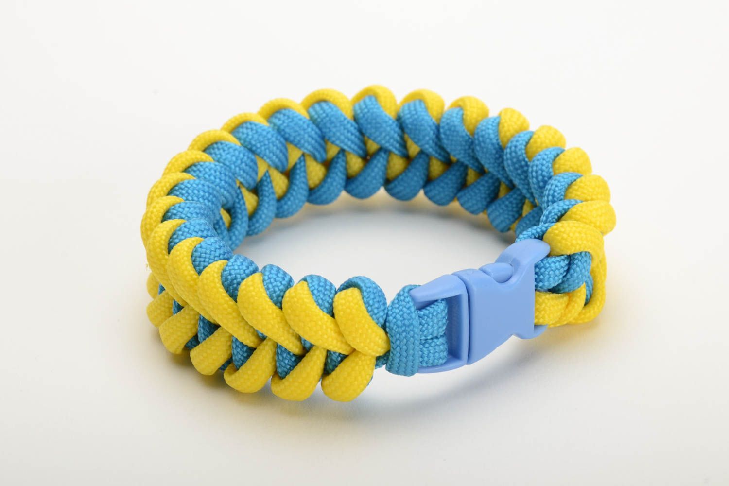 Handmade wrist survival bracelet woven of yellow and blue parachute cords photo 3