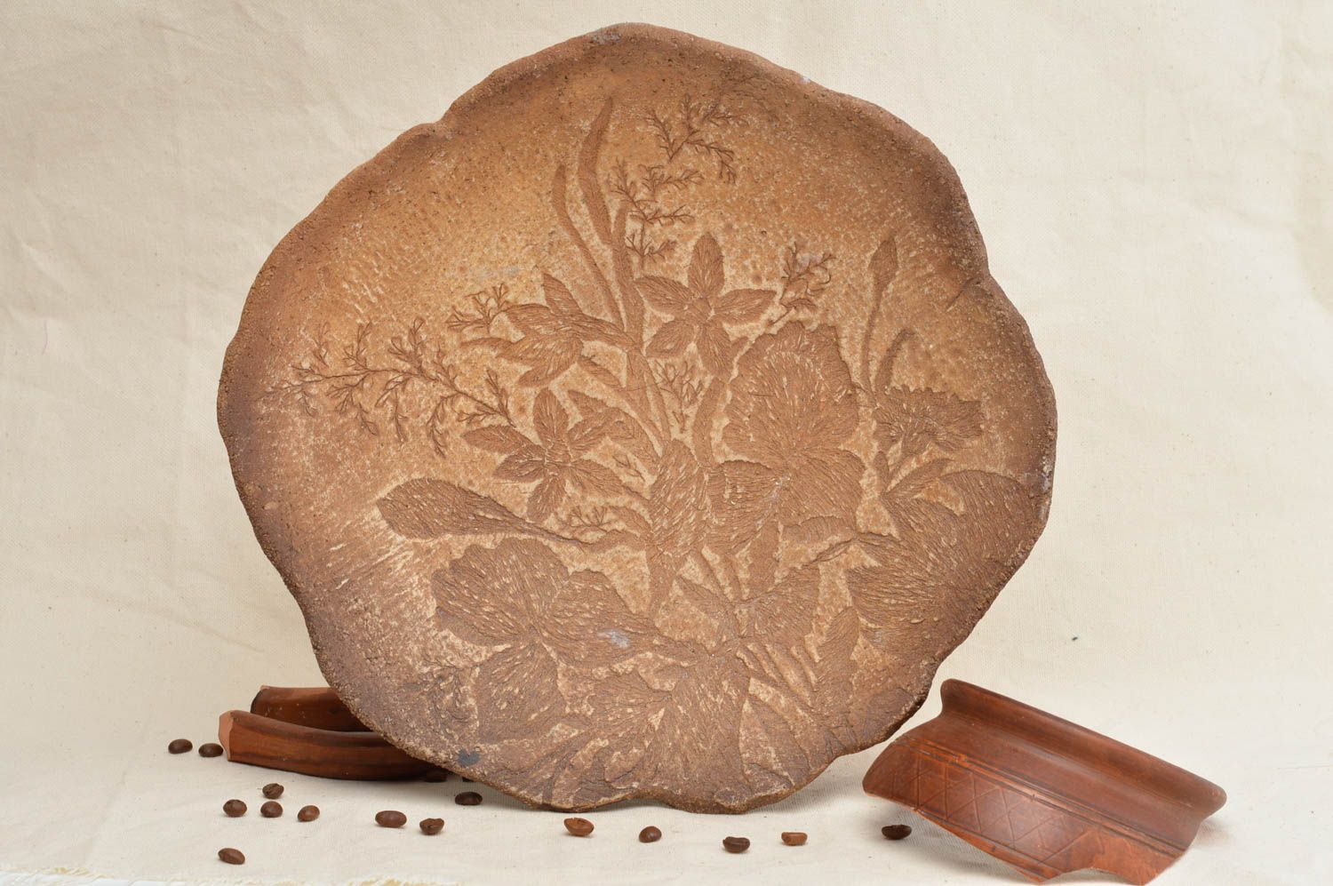 Assiette sur pieds ronde en argile à motif floral en relief faite main marron photo 1