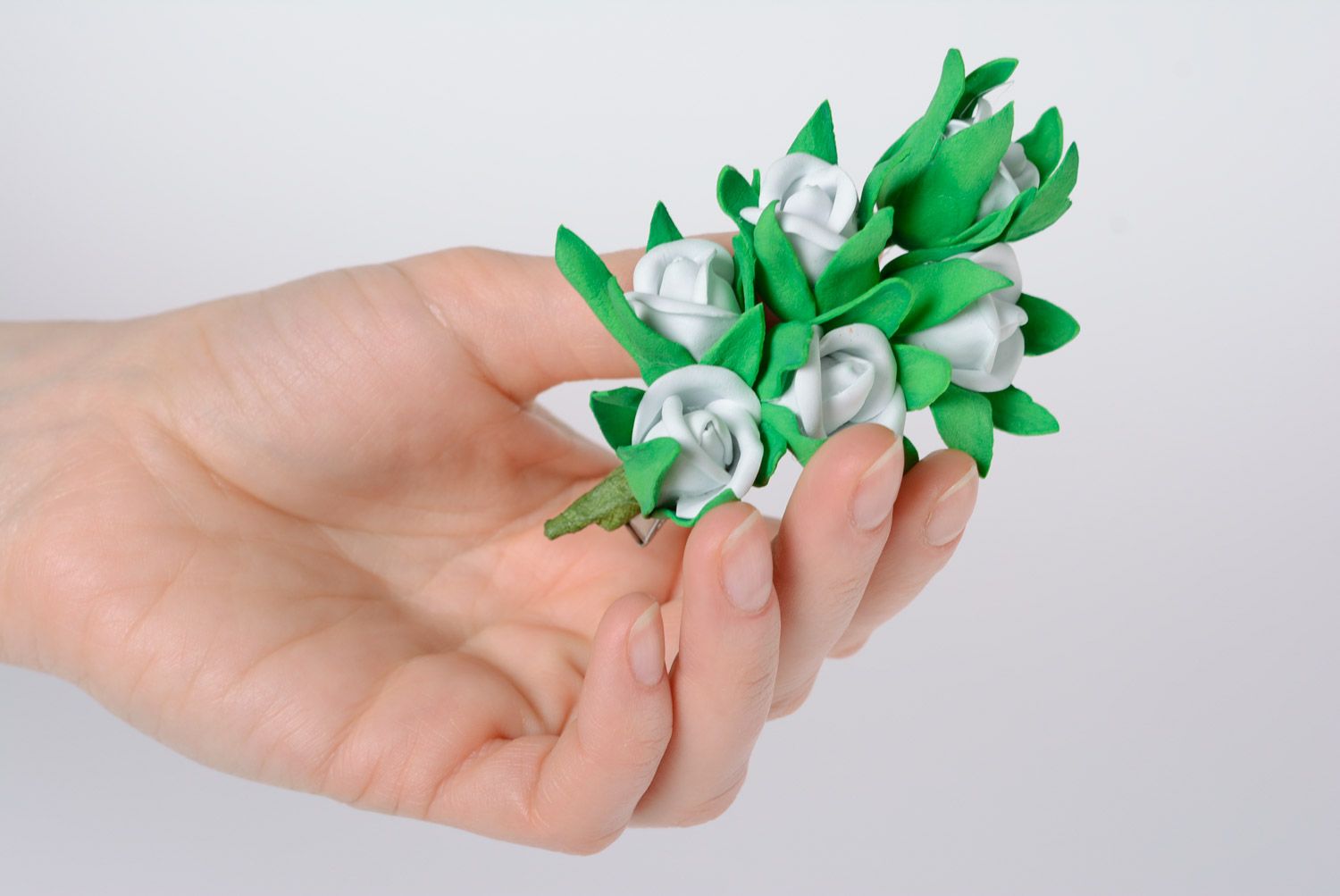 Stylish handmade foamiran fabric flower hair clip of white color with green petals photo 2