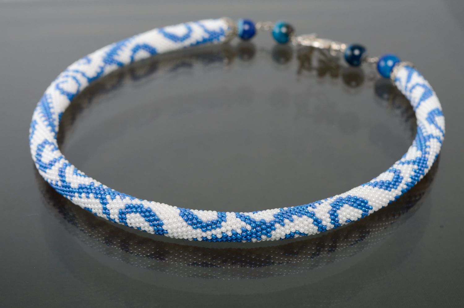 Blue and white beaded cord necklace with figured fastener photo 1