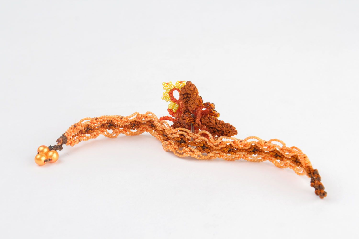 Bracelet made of threads and beads photo 5