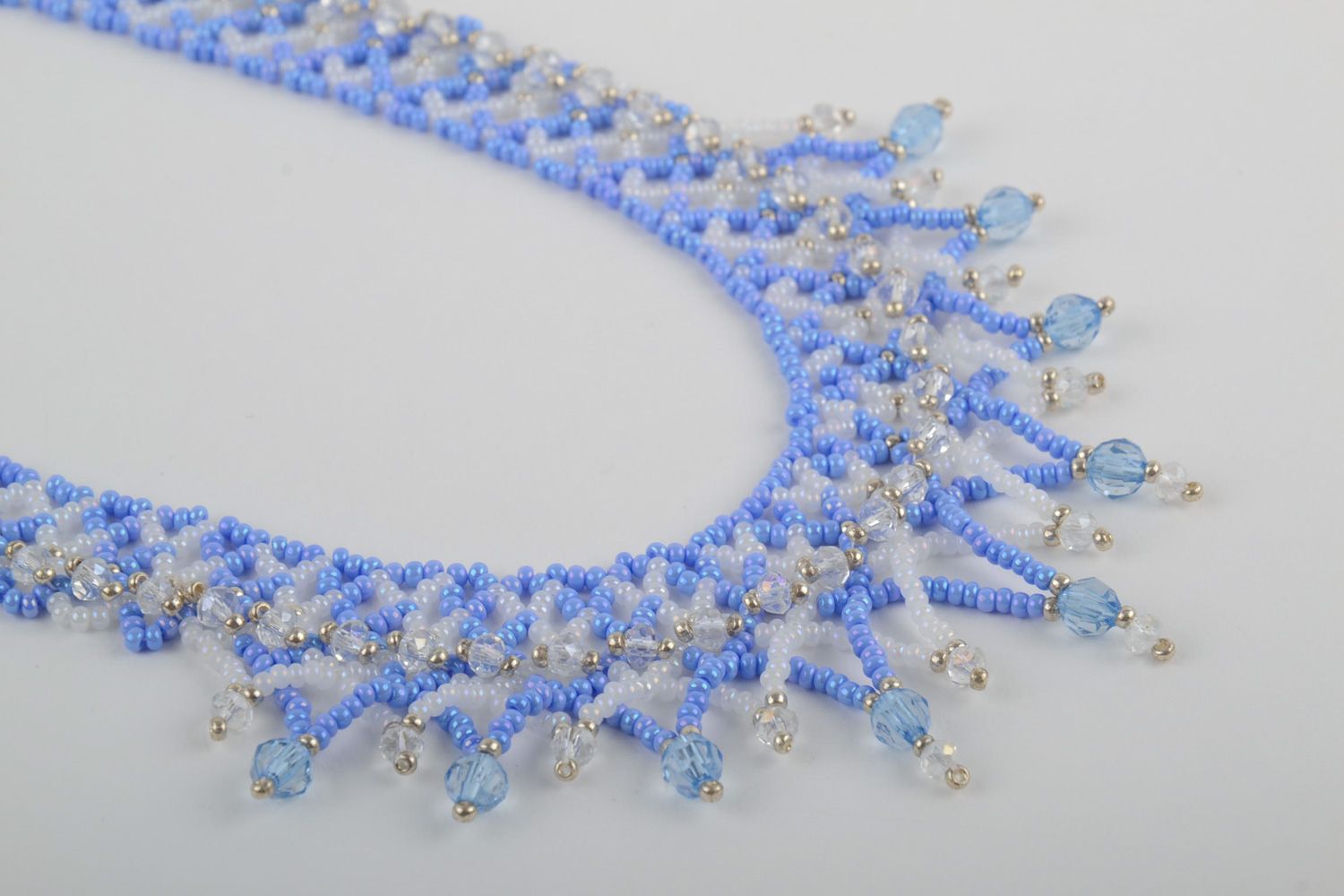 Handmade women's beaded necklace with charms of blue color photo 2