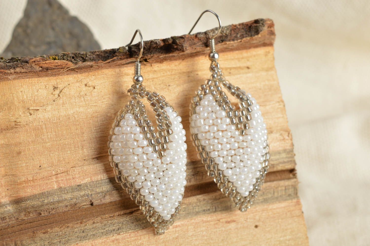 Handmade white and gray beaded woven dangle earrings in the shape of leaves photo 1