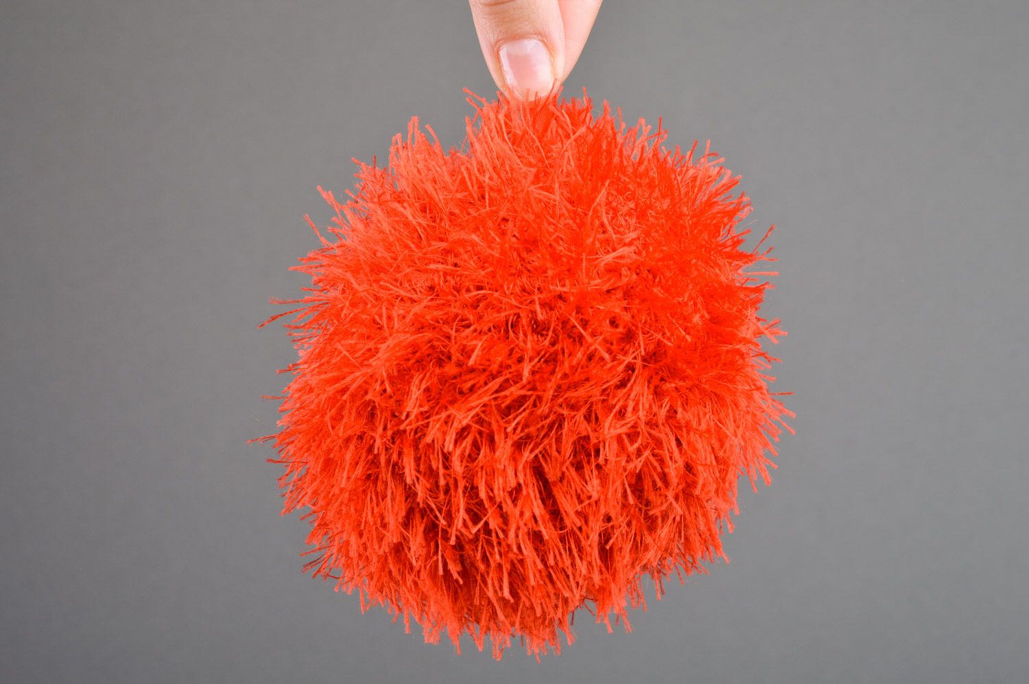 Handmade soft toy crocheted of red fluffy threads in the shape of ball for babies photo 3