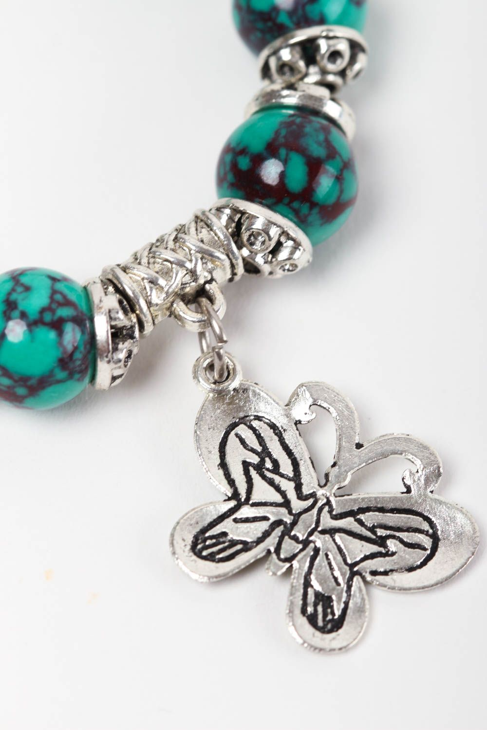 Natural turquoise stone beaded wrist bracelet with metal charms and central butterfly charm photo 3