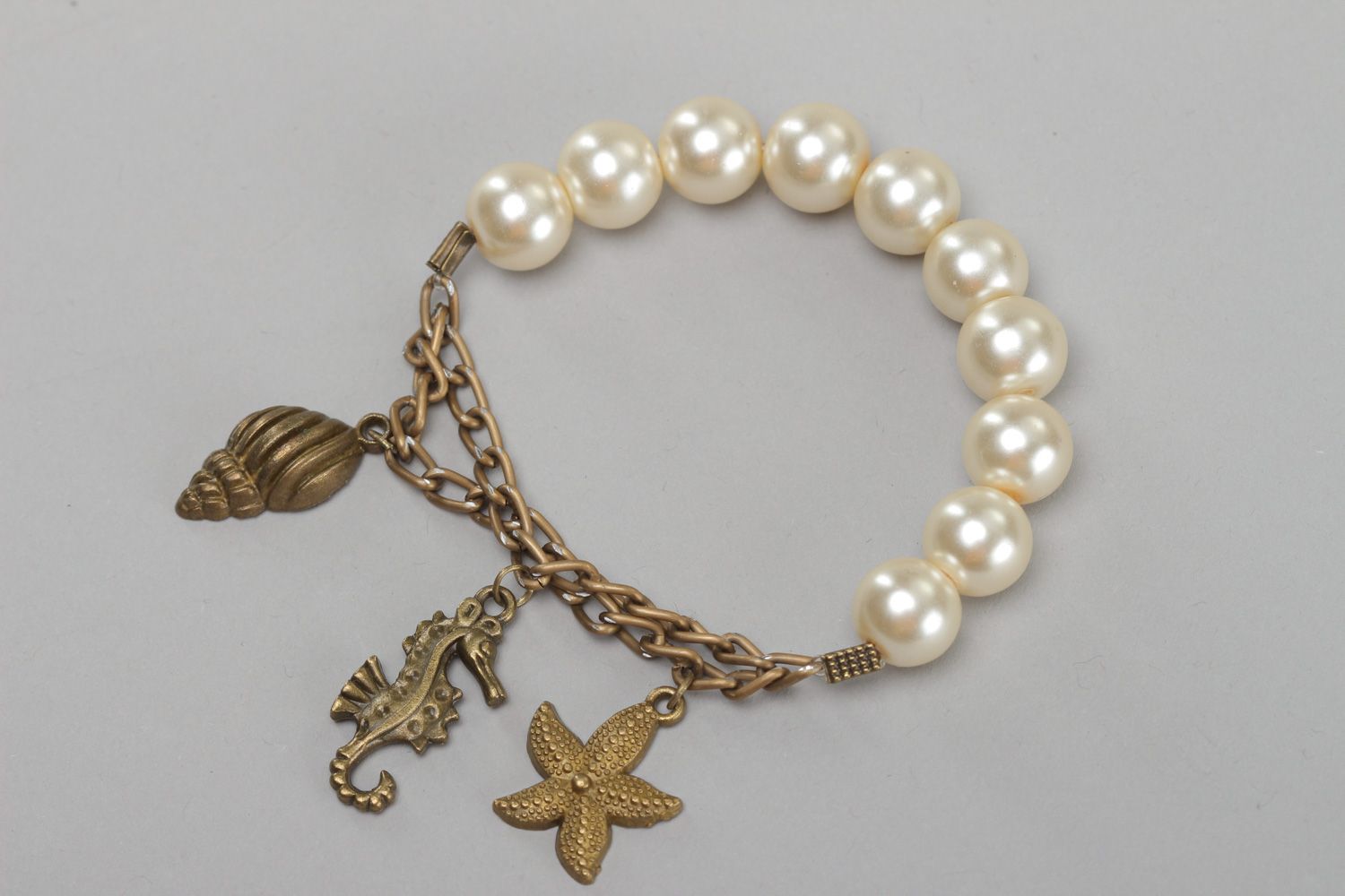 Elegant handmade bracelet with artificial pearls and metal charms for women photo 2