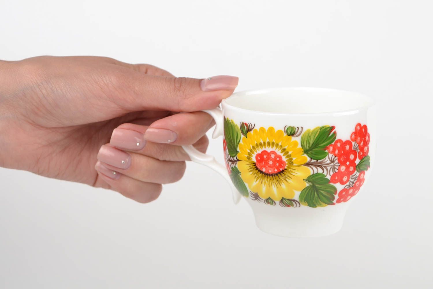 White porcelain handmade teacup with bright Russian-style floral pattern in green, red, and yellow color photo 2