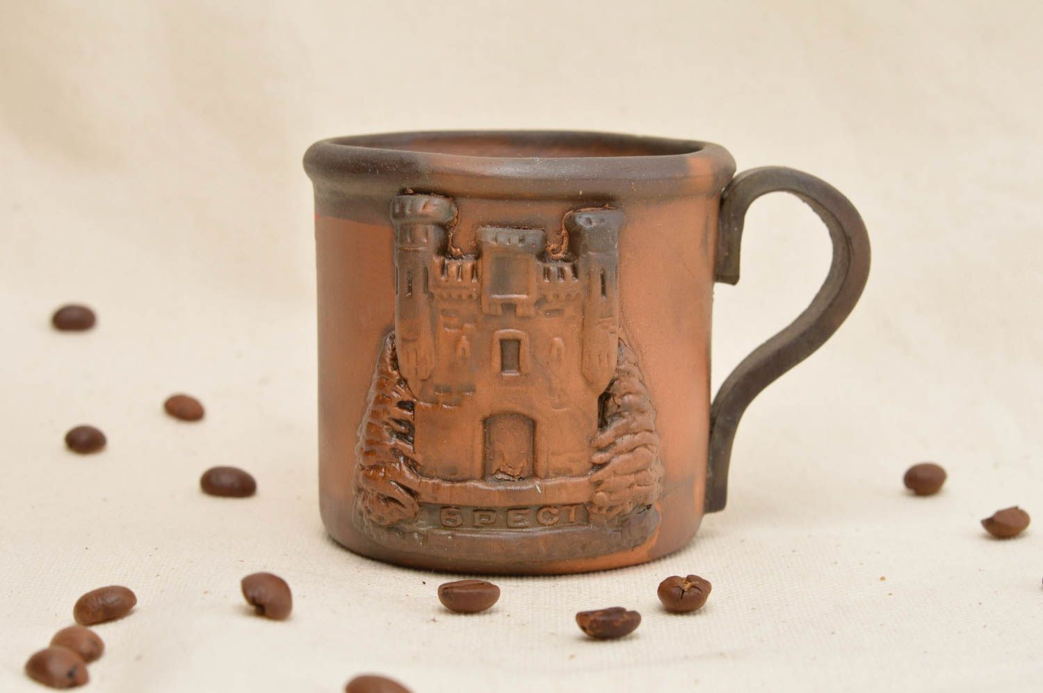 Clay coffee mug with handle and molded castle in brown color photo 1