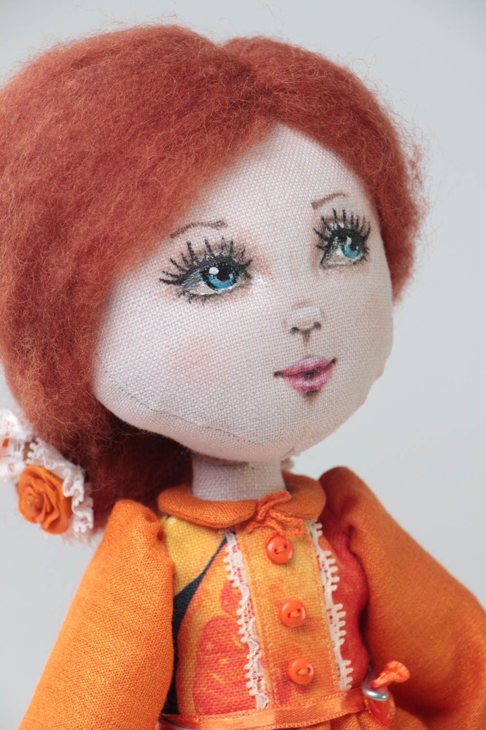 Handmade designer fabric soft doll in orange dress with thin lace on stand photo 3