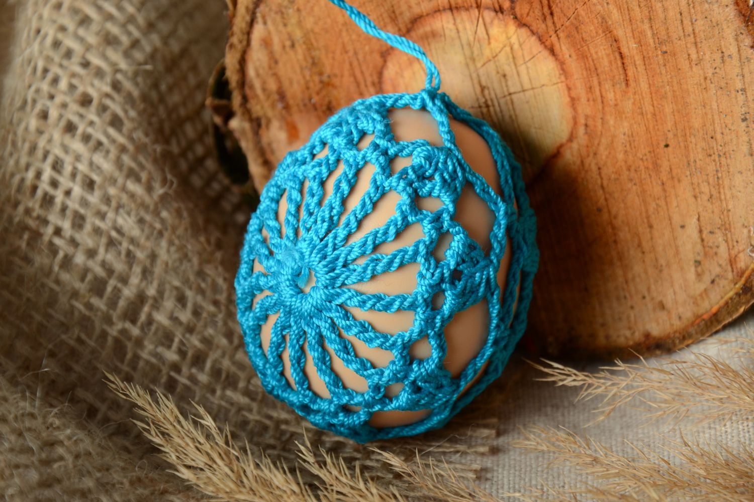 Homemade blue Easter egg crocheted over with cotton threads photo 1