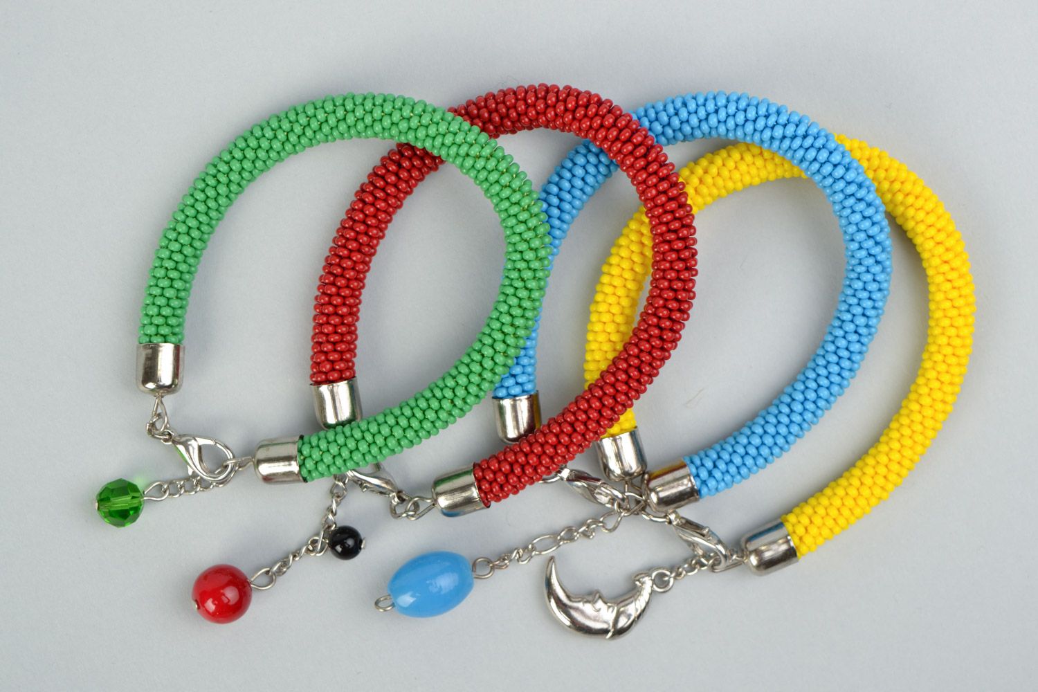 Set of bright beautiful braided handmade beaded bracelets 4 pieces photo 2