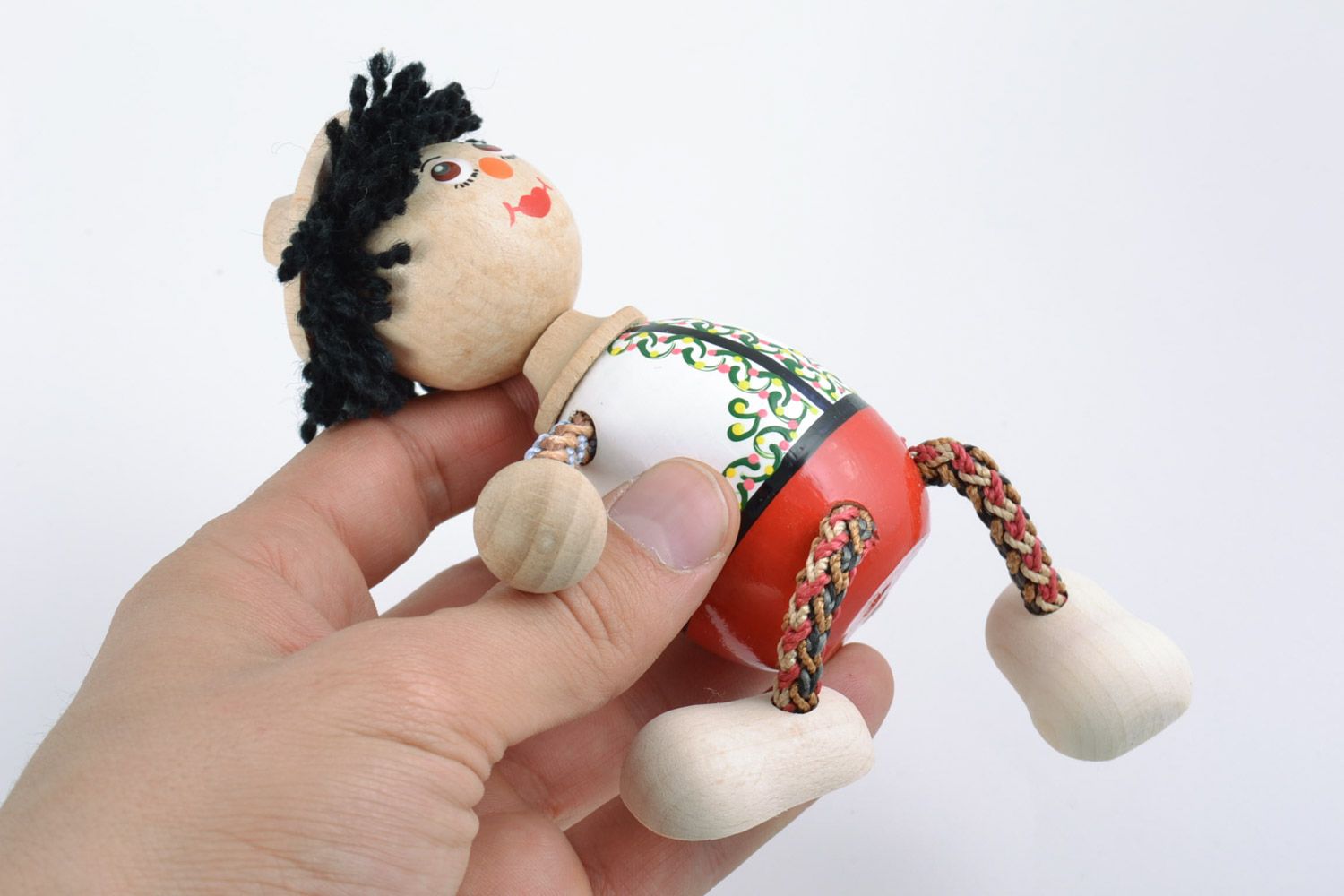 Small handmade painted wooden toy in the shape of boy photo 2