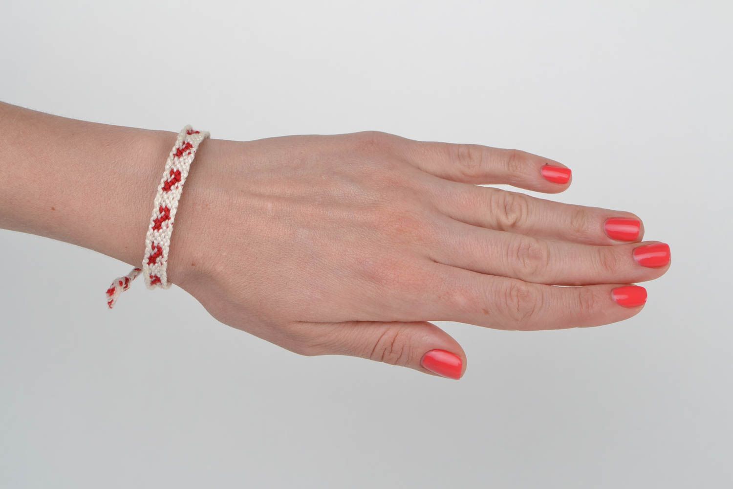 Handmade thin white and red friendship wrist bracelet woven of threads for girls photo 2