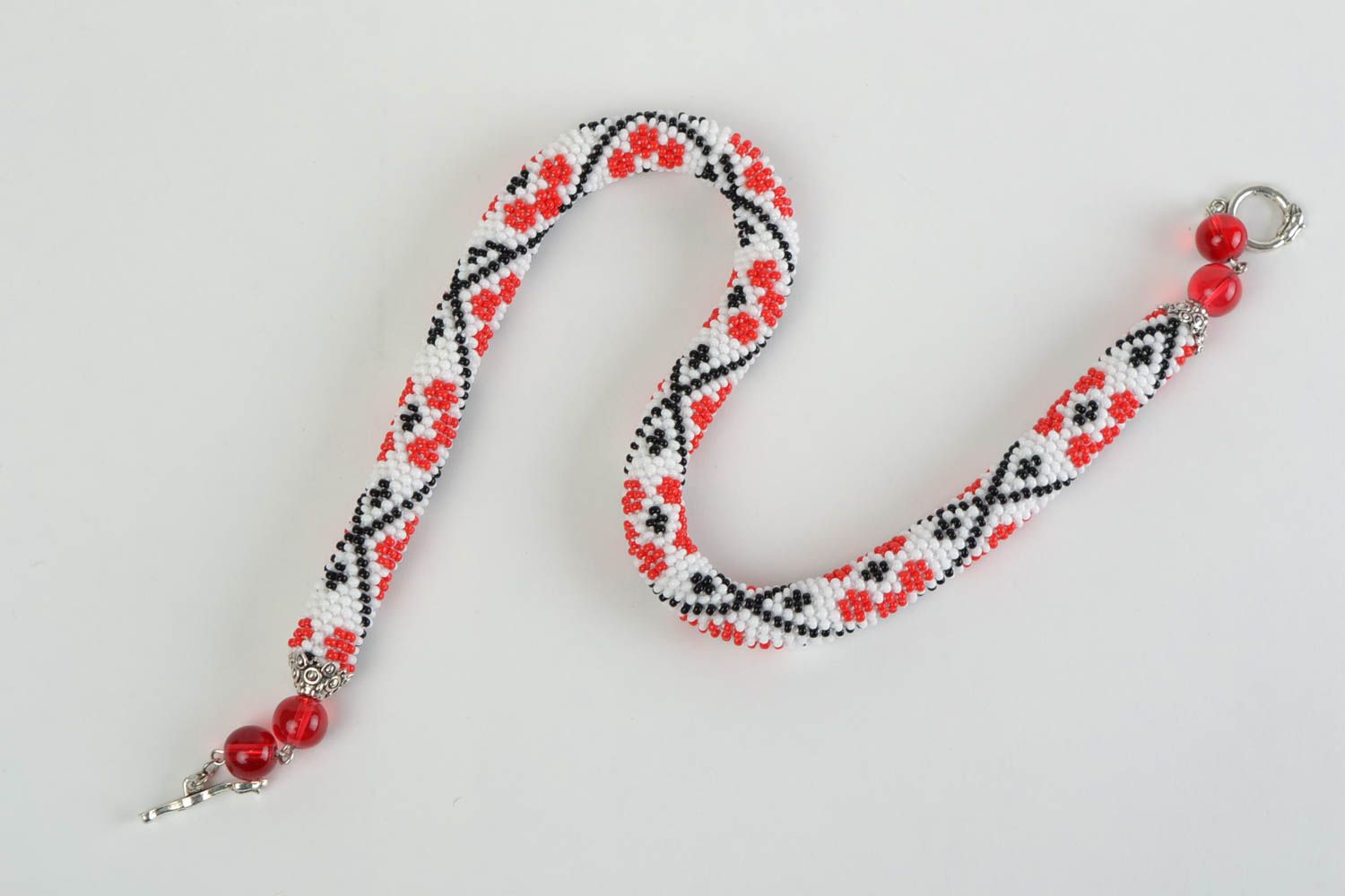 Handmade beaded cord necklace handmade with red flowers on white backgroun photo 2