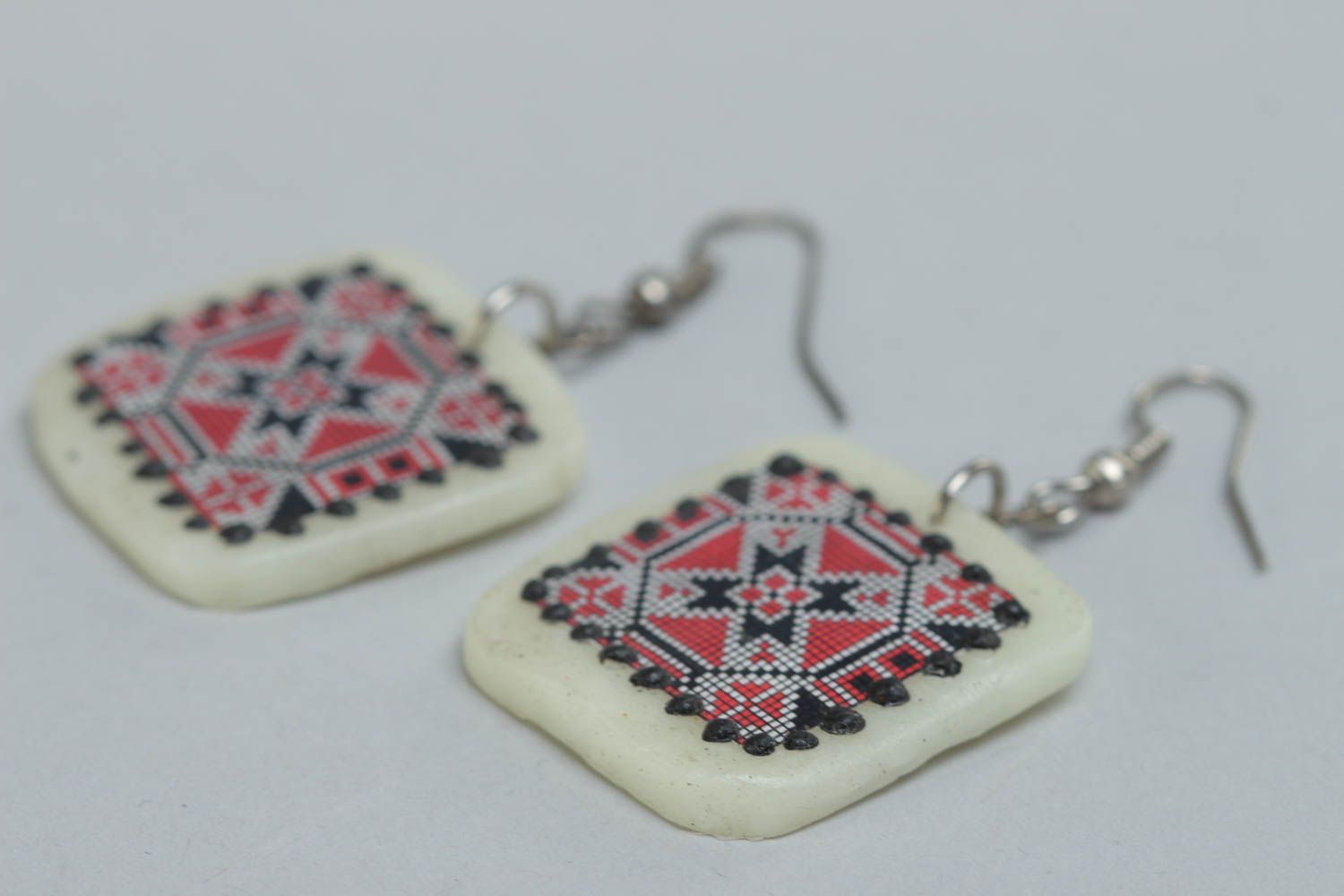 Handmade polymer clay white earrings with red and black ornament in ethnic style photo 3