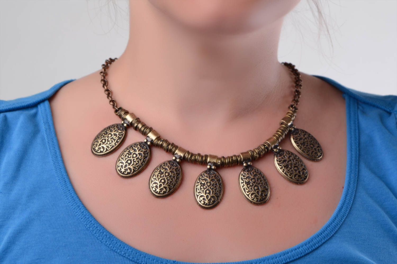 Handmade designer metal necklace of bronze color in ethnic style photo 1