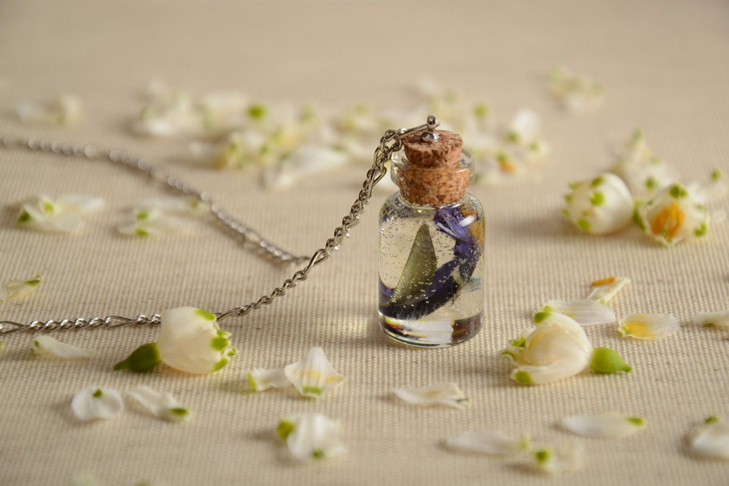 Handmade epoxy resin pendant with real flowers inside in the shape of vial photo 1