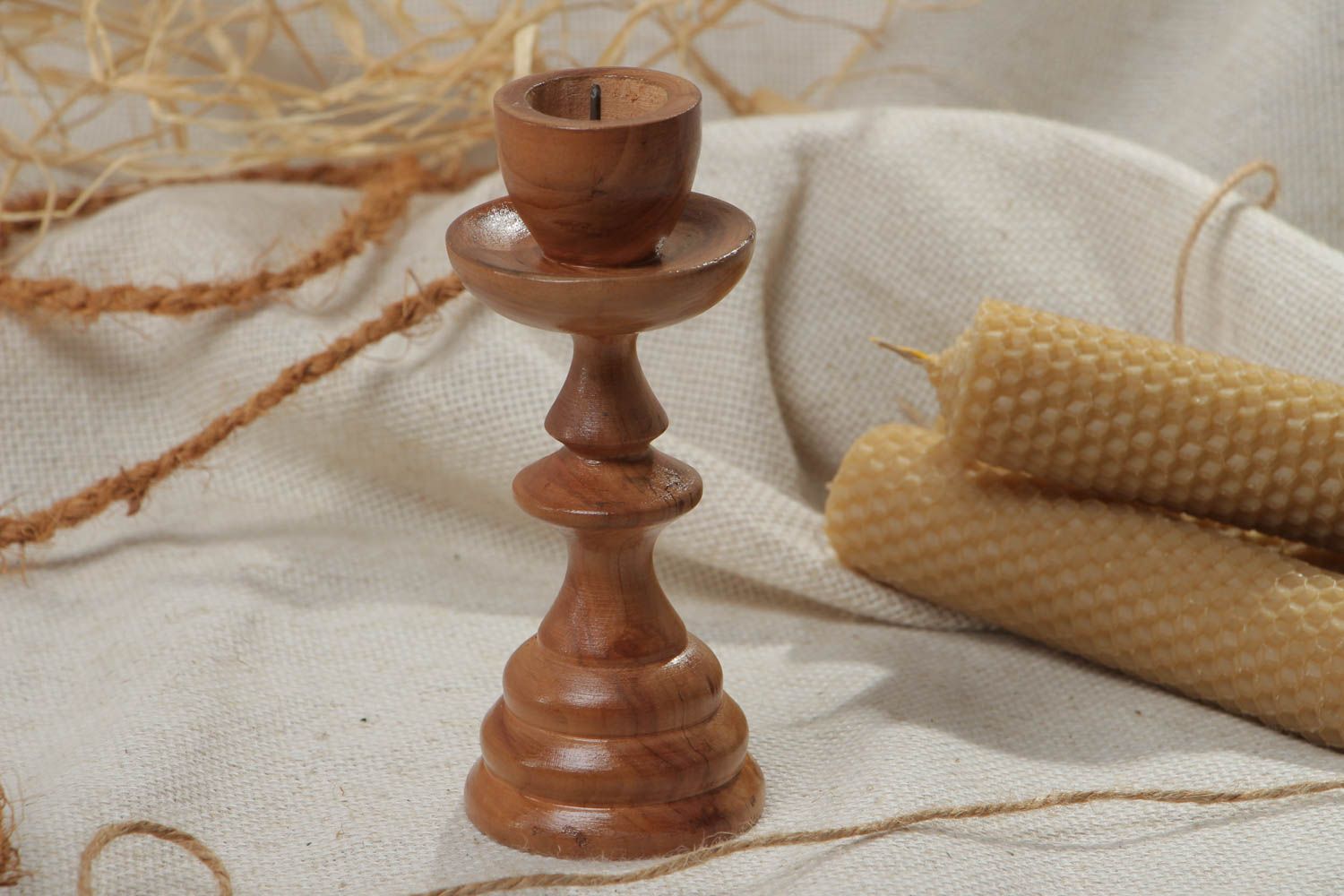 Handmade tall thin carved wooden candlestick of brown color for one candle photo 1