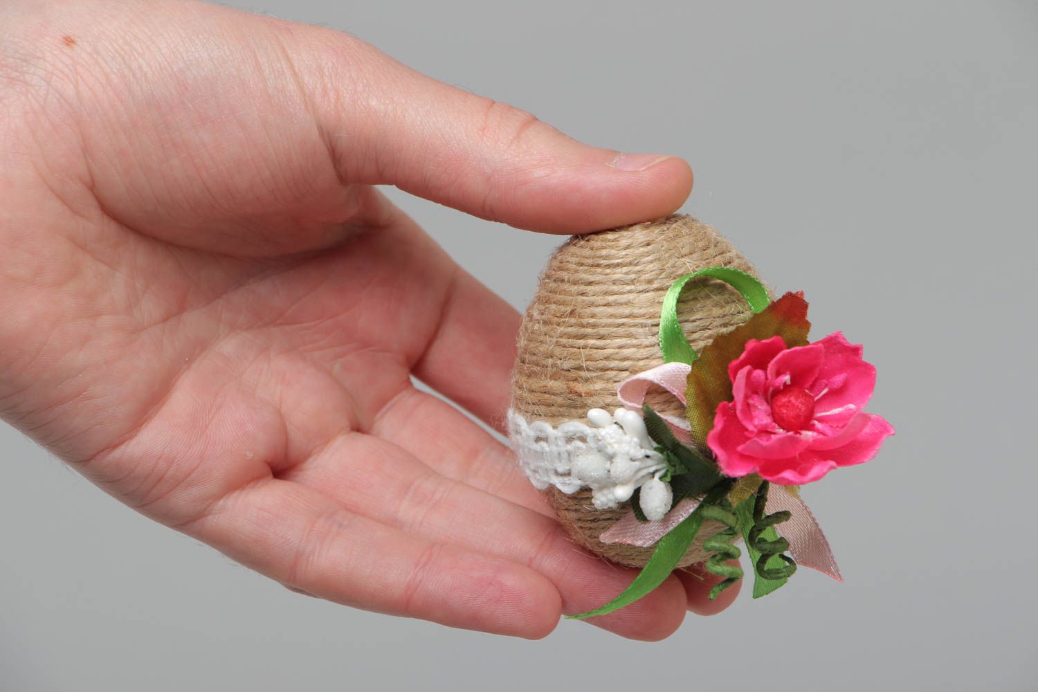 Handmade decorative wooden egg wrapped with twine with flowers for home decor photo 5