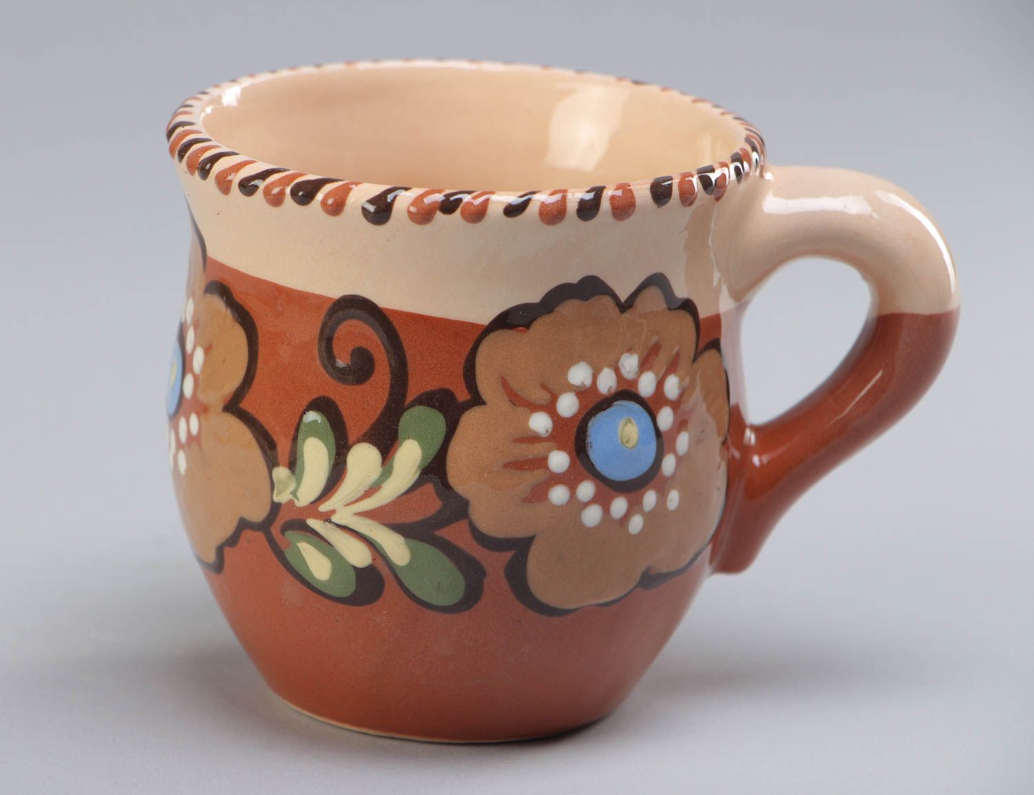 Decorative clay cup with handle and floral pattern in brown and beige color photo 2