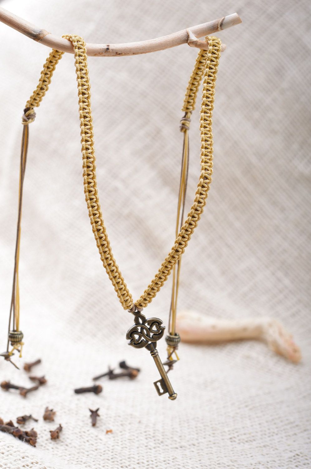 Handmade friendship wrist bracelet woven of cord with metal key-shaped charm photo 5