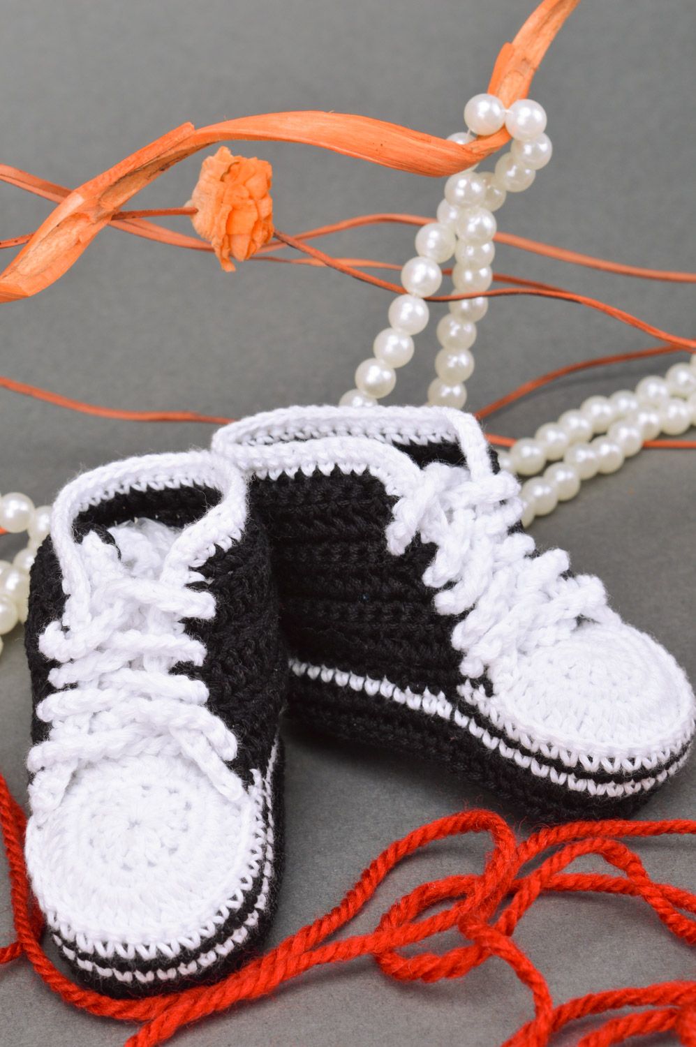 Handmade crochet baby booties in black and white colors with shoelaces photo 1