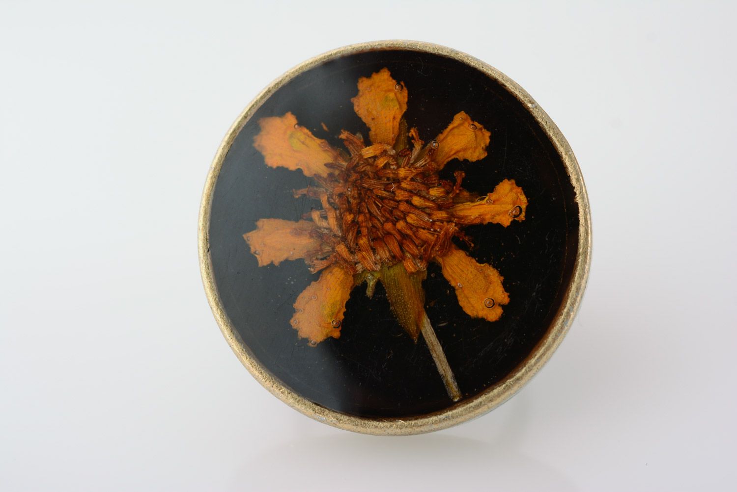 Handmade round metal ring with bright flower on black background in epoxy resin photo 2