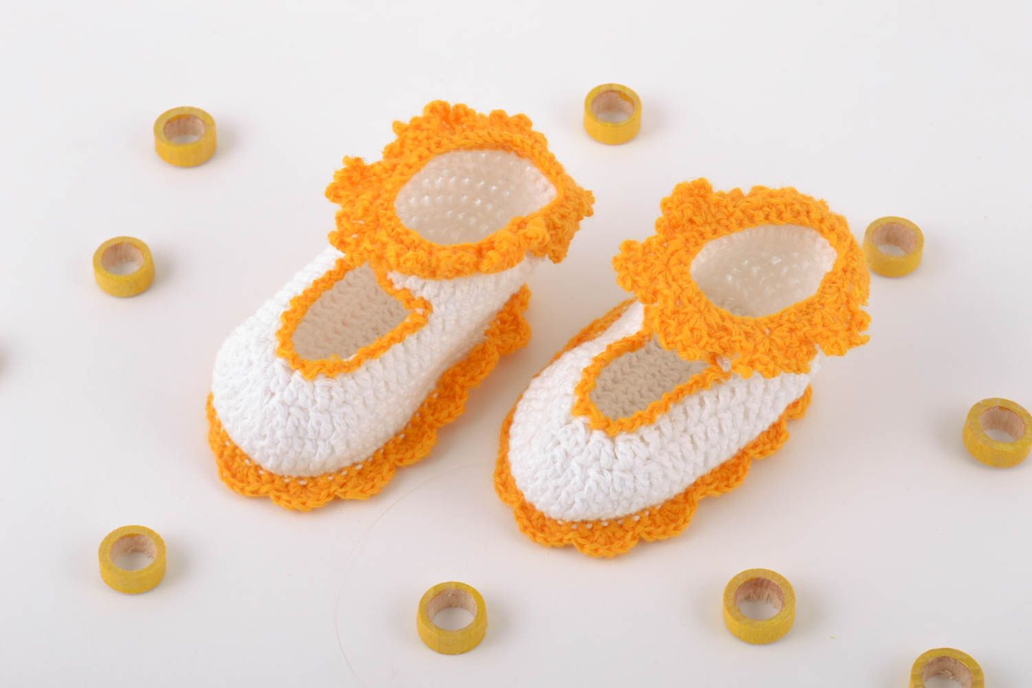 Handmade baby booties crocheted of natural white and orange cotton threads photo 1