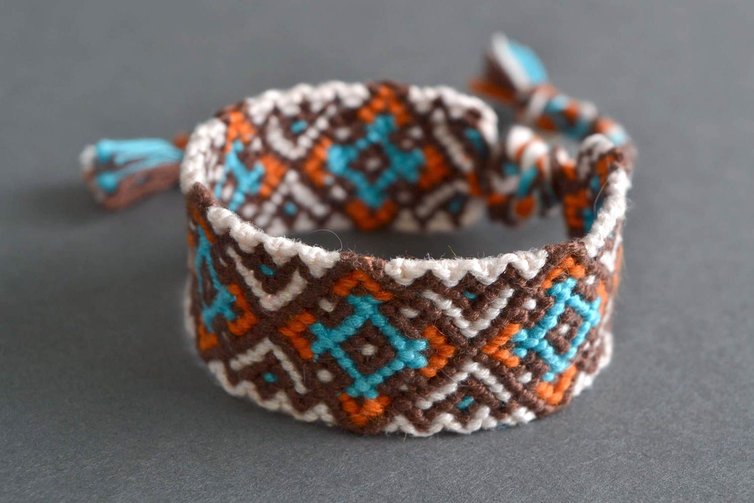 Handmade designer friendship wrist bracelet with ethnic ornament brown and blue photo 1